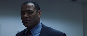 Movie still from “Mystic River” (2003), directed by Clint Eastwood – A man in a suit and tie; Close Up shot, Low angle