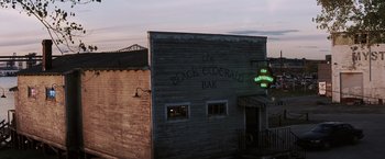 Movie still from “Mystic River” (2003), directed by Clint Eastwood – A building that has a sign on the side of the building; Extreme Wide shot, High angle