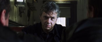 Movie still from “Mystic River” (2003), directed by Clint Eastwood – A person wearing a black shirt; Close Up shot, Over the shoulder angle