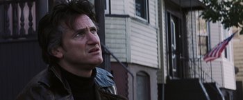 Movie still from “Mystic River” (2003), directed by Clint Eastwood – A person outside near a building; Close Up shot, Low angle