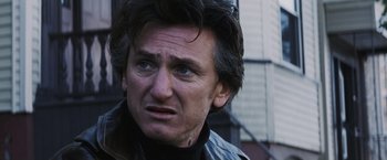 Movie still from “Mystic River” (2003), directed by Clint Eastwood – A person wearing a leather jacket; Close Up shot, Over the shoulder angle