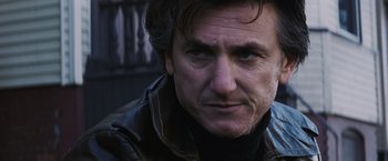 Movie still from “Mystic River” (2003), directed by Clint Eastwood – A person wearing a leather jacket; Close Up shot, Low angle