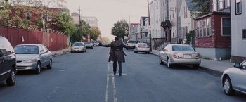 Movie still from “Mystic River” (2003), directed by Clint Eastwood – A person is crossing the street in the middle of the street; Wide shot, High angle