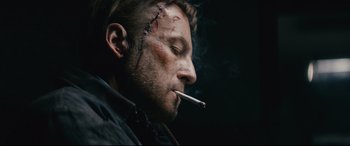 Movie still from “Nobody” (2021), directed by Ilya Naishuller – A person smoking a cigarette; Close Up shot, Low angle
