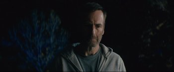 Movie still from “Nobody” (2021), directed by Ilya Naishuller – A person wearing a hooded sweatshirt; Close Up shot, Low angle