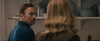 Movie still from “Nobody” (2021), directed by Ilya Naishuller – A man and a woman are looking at each other; Close Up shot, Over the shoulder angle