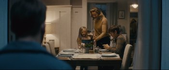 Movie still from “Nobody” (2021), directed by Ilya Naishuller – A woman and two children sitting at a dinner table; Medium shot, Over the shoulder angle