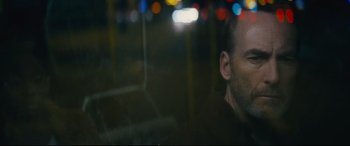 Movie still from “Nobody” (2021), directed by Ilya Naishuller – A person looking out of a car window; Close Up shot, Low angle