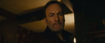 Movie still from “Nobody” (2021), directed by Ilya Naishuller – A person wearing a jacket; Close Up shot, Low angle