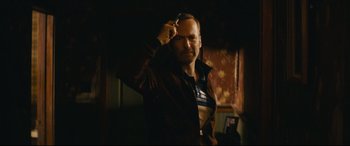 Movie still from “Nobody” (2021), directed by Ilya Naishuller – A man holding a cell phone up to his head; Close Up shot, Low angle