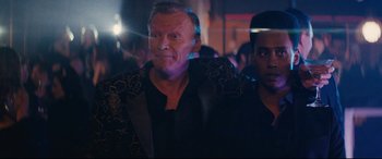 Movie still from “Nobody” (2021), directed by Ilya Naishuller – A person wearing a suit and tie; Close Up shot, Over the shoulder angle