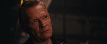 Movie still from “Nobody” (2021), directed by Ilya Naishuller – A person with a scar on his face; Close Up shot, High angle