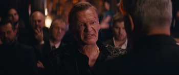 Movie still from “Nobody” (2021), directed by Ilya Naishuller – An old man with a scar on his face; Close Up shot, Over the shoulder angle