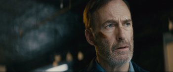 Movie still from “Nobody” (2021), directed by Ilya Naishuller – A person wearing a blue shirt; Close Up shot, Low angle