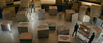 Movie still from “Nobody” (2021), directed by Ilya Naishuller – A room filled with lots of boxes and chairs on the floor; Extreme Wide shot, High angle