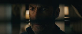 Movie still from “Nobody” (2021), directed by Ilya Naishuller – A person looking at the camera; Extreme Close Up shot, Low angle