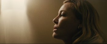 Movie still from “Nobody” (2021), directed by Ilya Naishuller – A woman's face in the sunlight; Close Up shot, Low angle