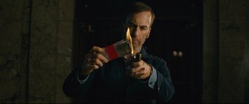 Movie still from “Nobody” (2021), directed by Ilya Naishuller – A man lighting a match with a cigarette lighter; Close Up shot, Low angle