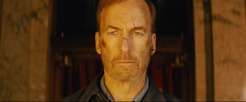 Movie still from “Nobody” (2021), directed by Ilya Naishuller – A person wearing a jacket; Close Up shot, Low angle