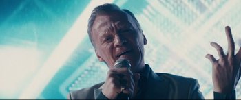 Movie still from “Nobody” (2021), directed by Ilya Naishuller – A person holding a microphone; Close Up shot, Low angle