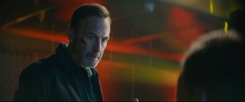 Movie still from “Nobody” (2021), directed by Ilya Naishuller – A person wearing a black shirt; Close Up shot, Low angle