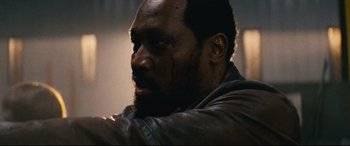 Movie still from “Nobody” (2021), directed by Ilya Naishuller – A person wearing a leather jacket; Close Up shot, Over the shoulder angle