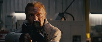 Movie still from “Nobody” (2021), directed by Ilya Naishuller – A man holding a knife in his mouth; Close Up shot, Low angle