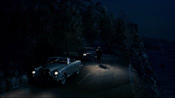Movie still from “North by Northwest” (1959), directed by Alfred Hitchcock – A man standing next to a car on the side of the road; Extreme Wide shot, High angle