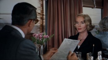 Movie still from “North by Northwest” (1959), directed by Alfred Hitchcock – A man and a woman sitting at a restaurant table; Medium shot, Over the shoulder angle
