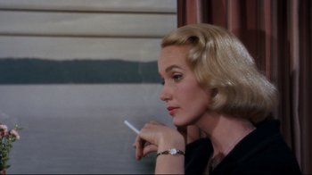 Movie still from “North by Northwest” (1959), directed by Alfred Hitchcock – A woman holding a cigarette in her hand; Close Up shot, Over the shoulder angle