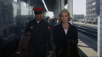Movie still from “North by Northwest” (1959), directed by Alfred Hitchcock – A man and a woman walking down a train platform; Medium shot, Low angle