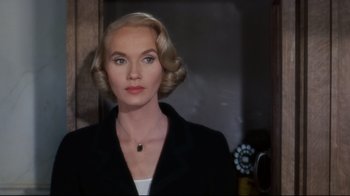 Movie still from “North by Northwest” (1959), directed by Alfred Hitchcock – A woman with blonde hair wearing a black jacket; Close Up shot, Over the shoulder angle