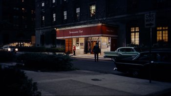 Movie still from “North by Northwest” (1959), directed by Alfred Hitchcock – A man walking down the sidewalk in front of a building; Extreme Wide shot, High angle