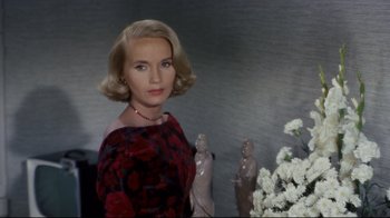 Movie still from “North by Northwest” (1959), directed by Alfred Hitchcock – A woman standing next to a vase of flowers; Close Up shot, High angle