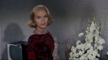 Movie still from “North by Northwest” (1959), directed by Alfred Hitchcock – A woman with blonde hair wearing a red and black checkered dress; Close Up shot, Low angle