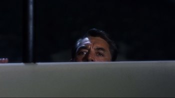 Movie still from “North by Northwest” (1959), directed by Alfred Hitchcock – A person looking over a wall; Close Up shot, Low angle