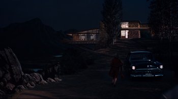Movie still from “North by Northwest” (1959), directed by Alfred Hitchcock – A woman is walking in the dark near a house; Extreme Wide shot, Low angle