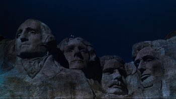 Movie still from “North by Northwest” (1959), directed by Alfred Hitchcock – A man standing on top of a rock formation; Extreme Wide shot, Low angle
