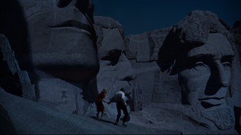 Movie still from “North by Northwest” (1959), directed by Alfred Hitchcock – Two people are playing a game in the dark; Extreme Wide shot, High angle