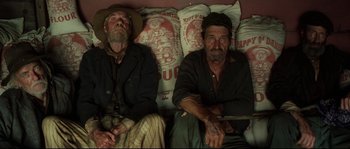 Movie still from “O Brother, Where Art Thou?” (2000), directed by Joel Coen – A couple of men sitting next to each other on pillows; Medium shot, Overhead angle