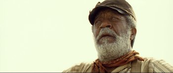 Movie still from “O Brother, Where Art Thou?” (2000), directed by Joel Coen – An older man with a beard and a hat; Close Up shot, Low angle