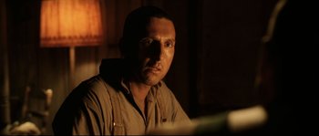 Movie still from “O Brother, Where Art Thou?” (2000), directed by Joel Coen – A person sitting in a room; Close Up shot, Low angle