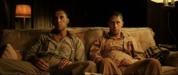 Movie still from “O Brother, Where Art Thou?” (2000), directed by Joel Coen – A couple of men sitting on top of a couch; Medium shot, Low angle