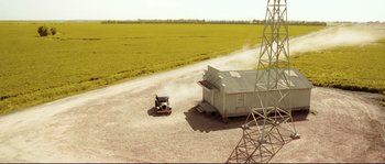 Movie still from “O Brother, Where Art Thou?” (2000), directed by Joel Coen – An aerial view of an old truck driving down a dirt road; Extreme Wide shot, High angle