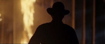 Movie still from “O Brother, Where Art Thou?” (2000), directed by Joel Coen – A man wearing a hat is standing in front of a window; Close Up shot, Low angle