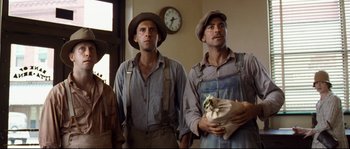 Movie still from “O Brother, Where Art Thou?” (2000), directed by Joel Coen – A couple of men standing next to each other in a room; Medium shot, Low angle