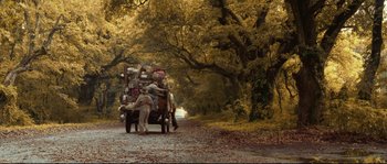 Movie still from “O Brother, Where Art Thou?” (2000), directed by Joel Coen – A truck with a lot of luggage on the back of it; Wide shot, Low angle