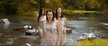 Movie still from “O Brother, Where Art Thou?” (2000), directed by Joel Coen – Three young women are standing in the water; Medium shot, High angle