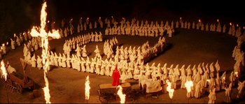 Movie still from “O Brother, Where Art Thou?” (2000), directed by Joel Coen – A man in a red robe standing in front of a group of people; Extreme Wide shot, High angle