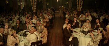 Movie still from “O Brother, Where Art Thou?” (2000), directed by Joel Coen – A group of people sitting at tables in a room; Wide shot, High angle